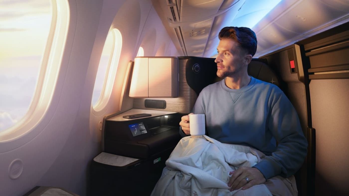 A passenger relaxing in a business class seat